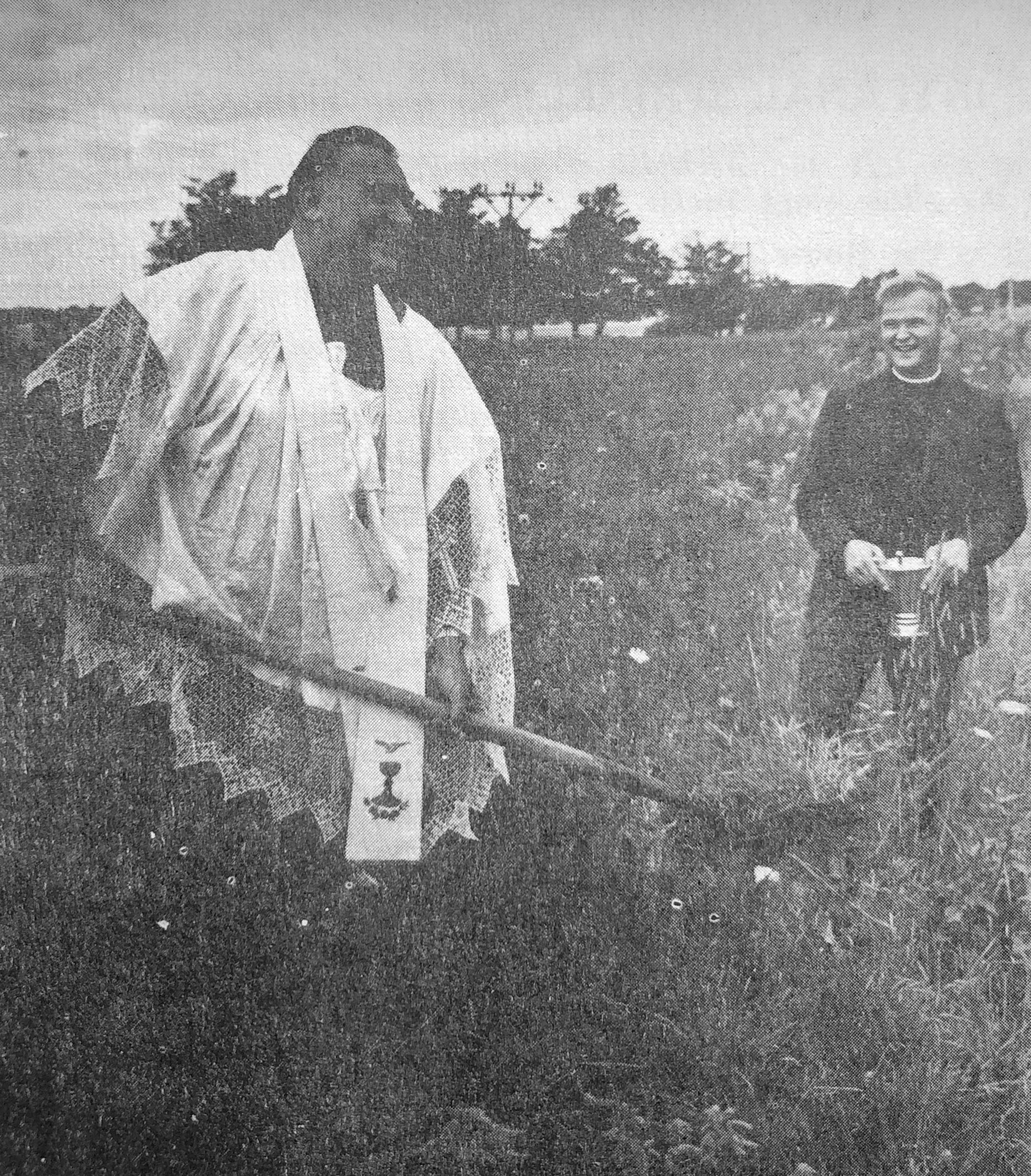 Photo of Fr. Mahoney with a shovel before construction